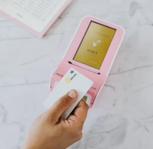 Pink POS terminal and PouchNation card