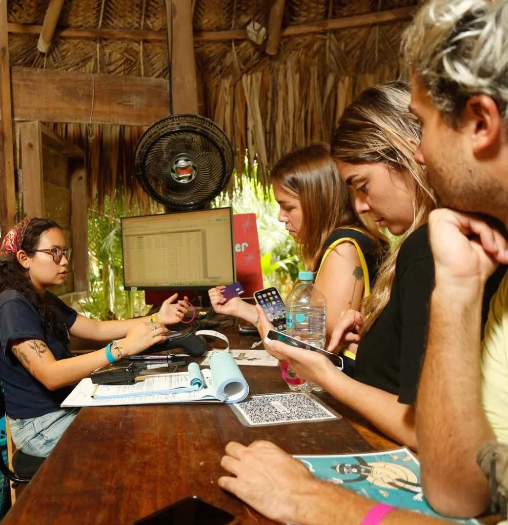 Three people at the hostel reception