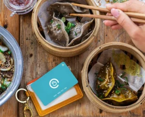 Pouchnation card next to the asian food plates